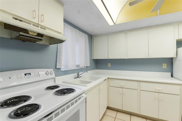 kitchen featuring sink, light tile patterned floors, and electric range