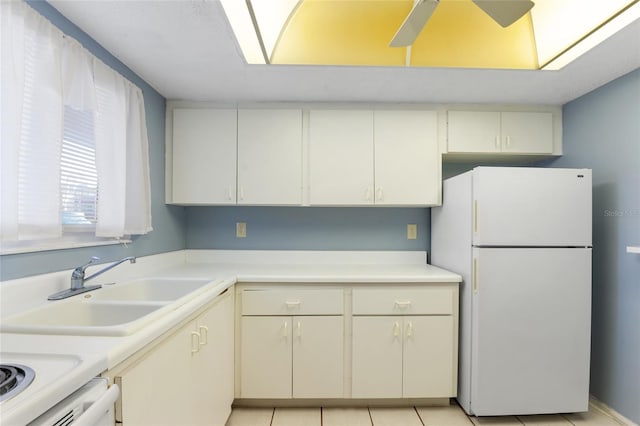 kitchen with white appliances, ceiling fan, light tile patterned floors, and sink