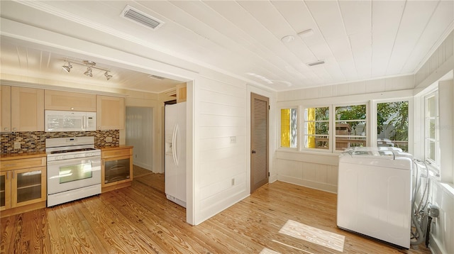 kitchen featuring wooden walls, white appliances, decorative backsplash, light brown cabinetry, and light wood-type flooring