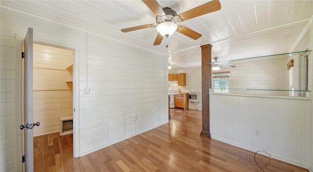 unfurnished room with wood walls and hardwood / wood-style floors