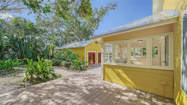 wooden deck featuring a sunroom