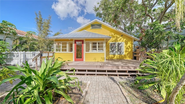 bungalow with a sunroom and a wooden deck