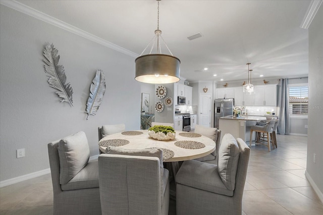 dining space featuring light tile patterned floors and crown molding