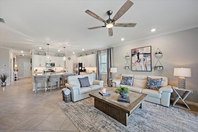 living room featuring ceiling fan, ornamental molding, and light tile patterned flooring