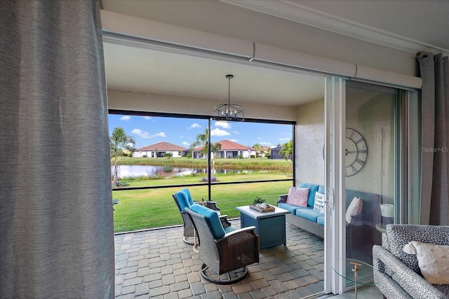 sunroom / solarium with a water view