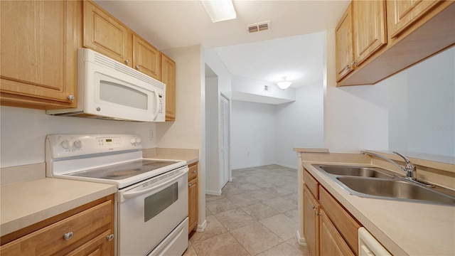 kitchen featuring light brown cabinetry, light tile patterned floors, white appliances, and sink