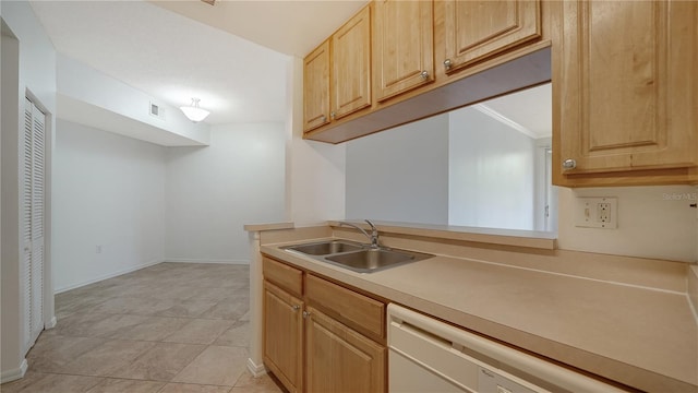 kitchen with dishwasher, light brown cabinets, light tile patterned flooring, and sink