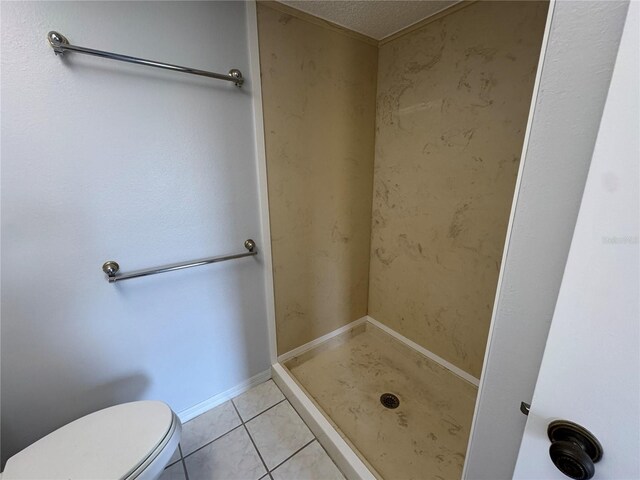 bathroom featuring tile patterned floors, walk in shower, a textured ceiling, and toilet