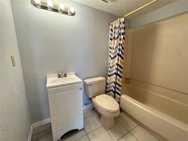 full bathroom featuring vanity, tile patterned floors, toilet, shower / bath combo with shower curtain, and a textured ceiling