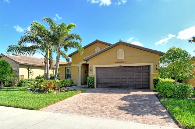 view of front facade with a front yard and a garage