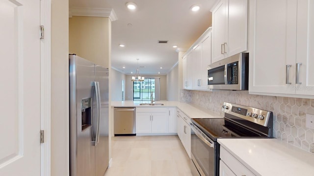 kitchen with white cabinetry, sink, appliances with stainless steel finishes, and crown molding