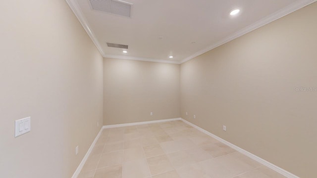 unfurnished room featuring light tile patterned flooring and ornamental molding