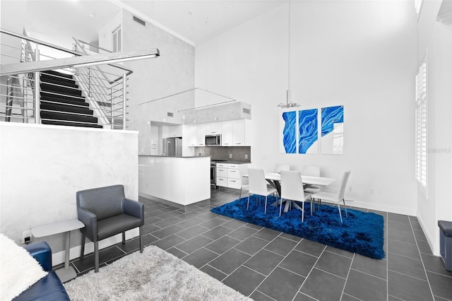 tiled living room featuring a high ceiling