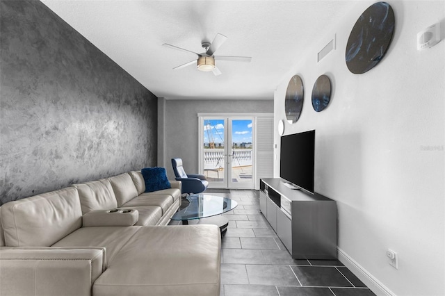 living room featuring french doors, a textured ceiling, dark tile patterned flooring, and ceiling fan