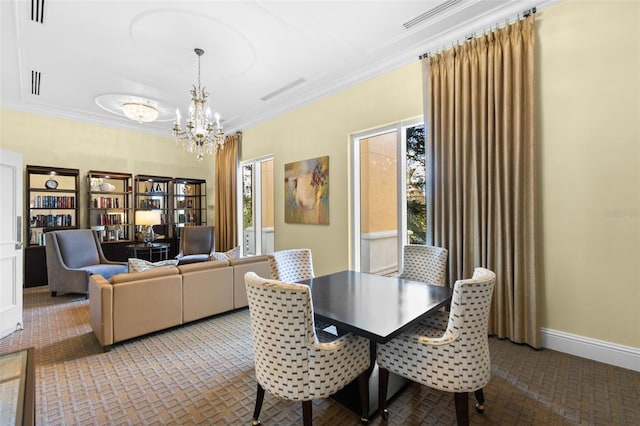 dining space featuring crown molding and an inviting chandelier