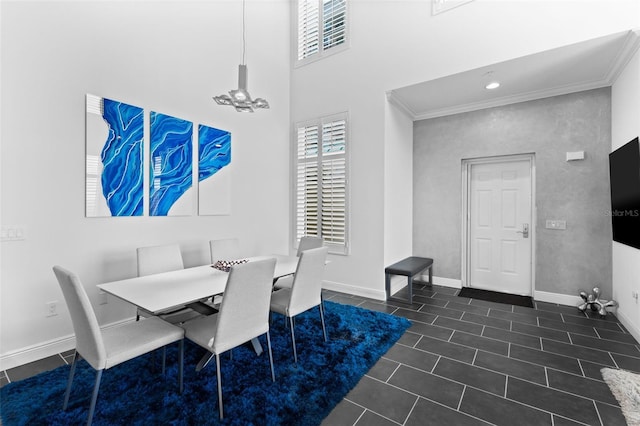 dining space featuring dark tile patterned flooring and ornamental molding