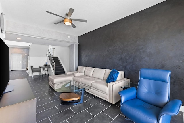 tiled living room with ceiling fan and a textured ceiling