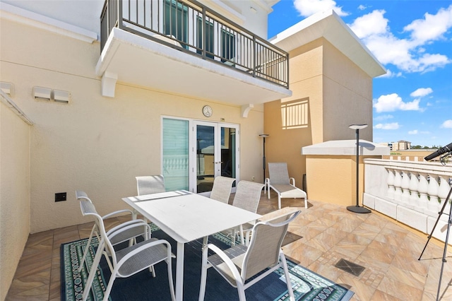 view of patio / terrace with a balcony and french doors