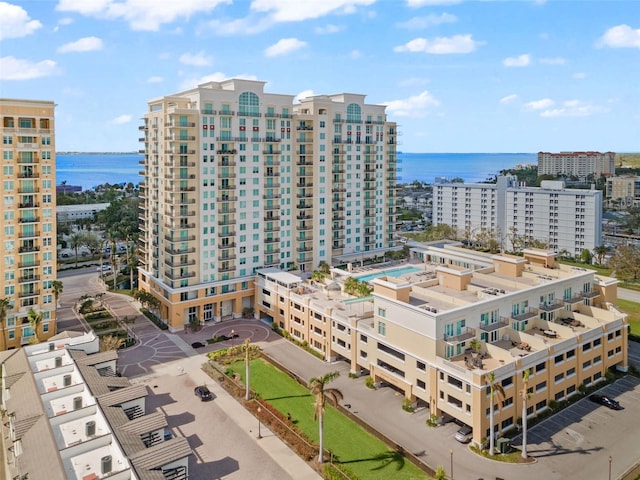 drone / aerial view featuring a view of city and a water view