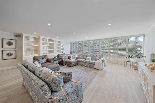 living room featuring crown molding and light wood-type flooring