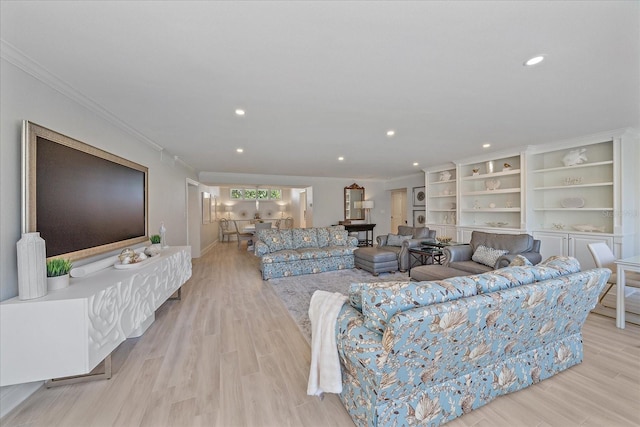 living room featuring light hardwood / wood-style flooring and ornamental molding