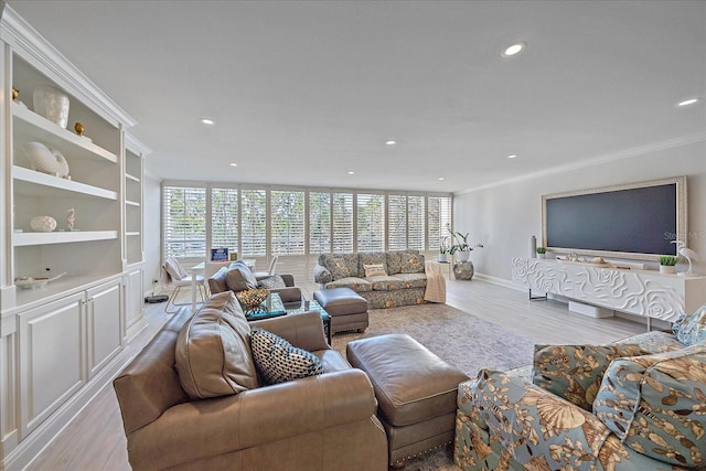 living room featuring light hardwood / wood-style flooring and crown molding