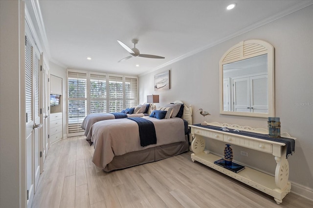 bedroom with ceiling fan, crown molding, and light hardwood / wood-style floors