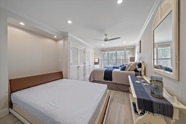 bedroom featuring light hardwood / wood-style flooring, ornamental molding, and ceiling fan