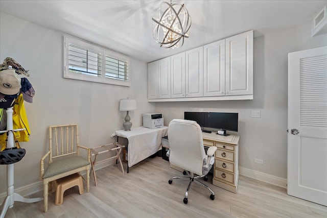 office space with a chandelier and light wood-type flooring