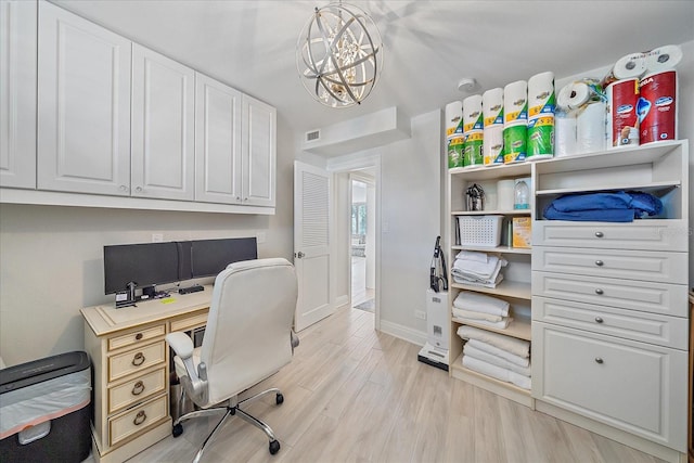 office area with a chandelier and light hardwood / wood-style floors