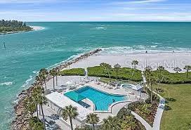 bird's eye view featuring a view of the beach and a water view