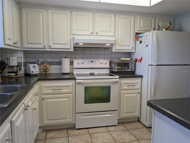 kitchen with white cabinets, electric range, white fridge, and range hood