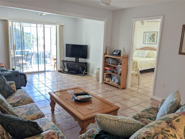 tiled living room with ceiling fan