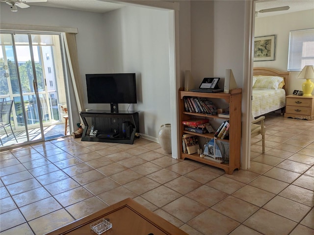 tiled living room featuring ceiling fan