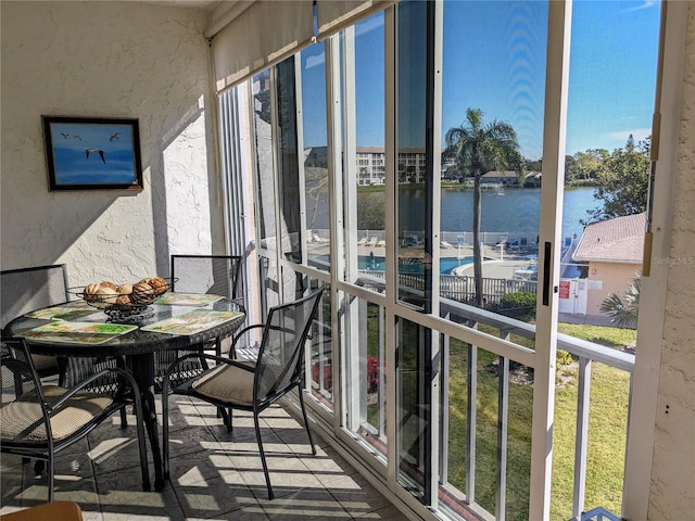 unfurnished sunroom with a water view