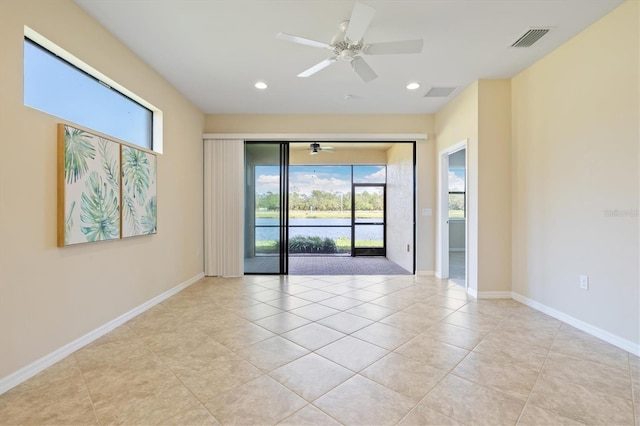 tiled empty room featuring ceiling fan