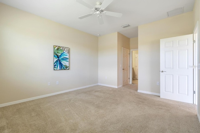 unfurnished room with ceiling fan and light carpet