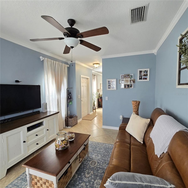 living room featuring crown molding, light tile patterned flooring, ceiling fan, and a textured ceiling