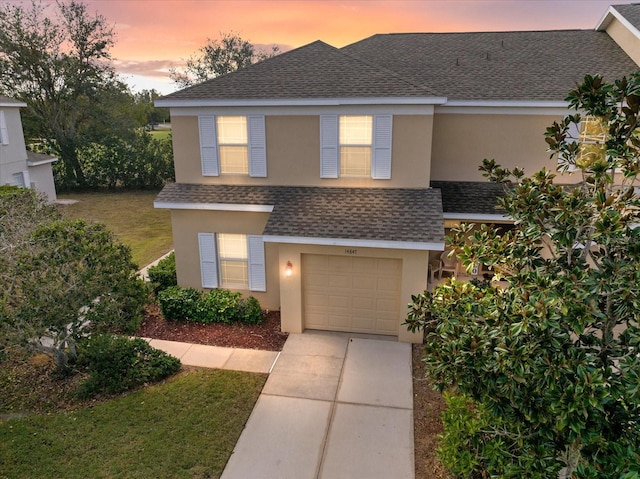 view of front facade with a garage and a lawn