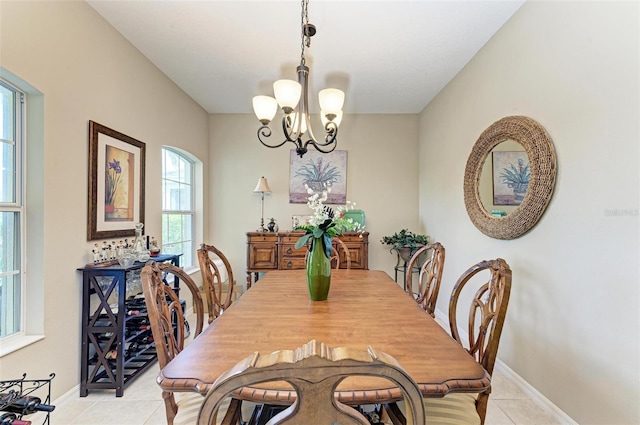 dining room featuring a notable chandelier and light tile patterned floors