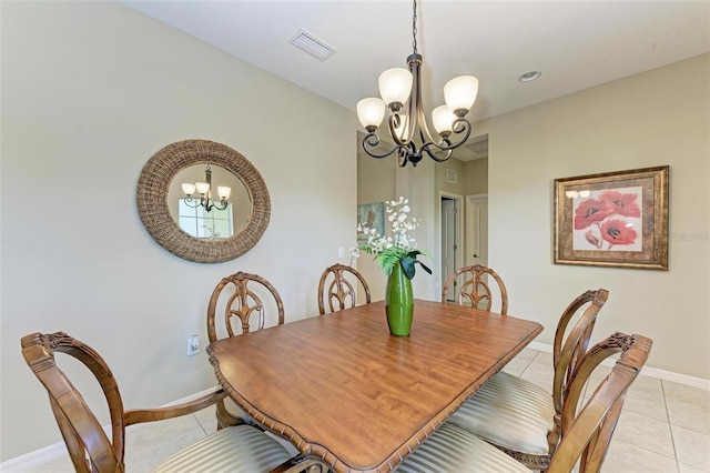 dining space featuring an inviting chandelier and light tile patterned flooring