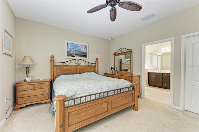 bedroom featuring connected bathroom, ceiling fan, and light colored carpet