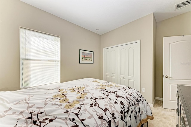 carpeted bedroom featuring a closet