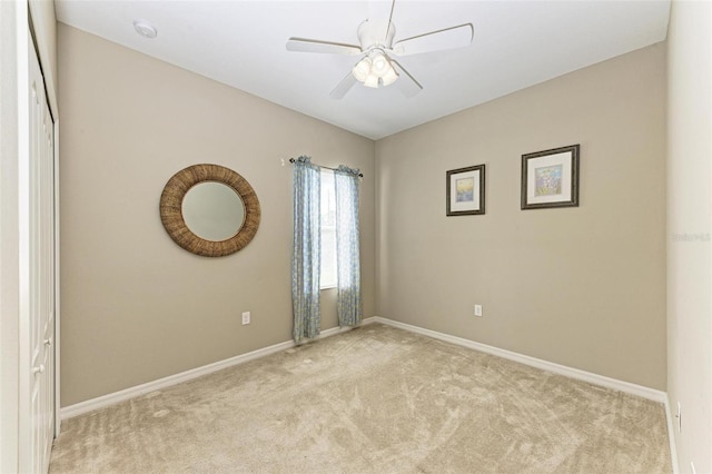 carpeted empty room featuring ceiling fan