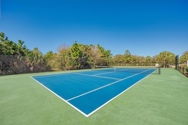 view of tennis court with basketball hoop