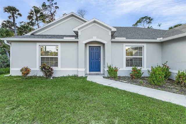 ranch-style house with a front lawn