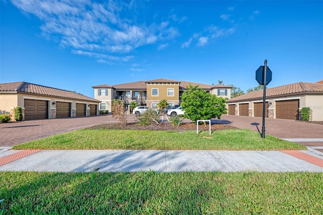 view of front of house with a front lawn and a garage