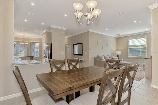 dining space featuring light tile patterned floors, ornamental molding, and a notable chandelier