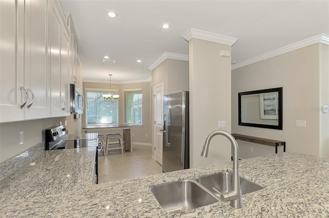 kitchen with white cabinets, sink, light stone countertops, ornamental molding, and stainless steel appliances