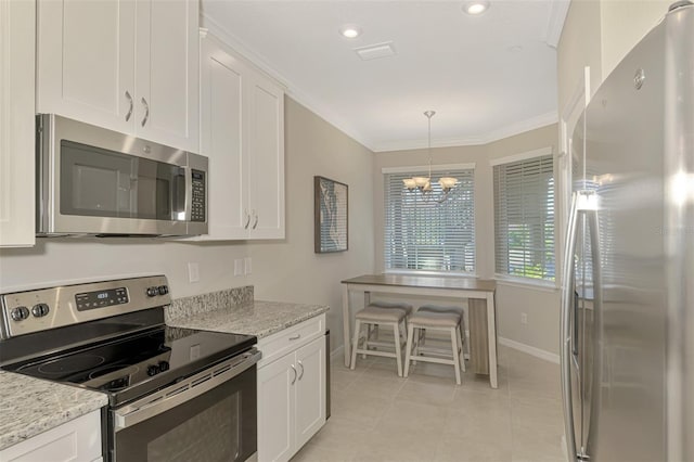 kitchen with light stone countertops, white cabinetry, and stainless steel appliances